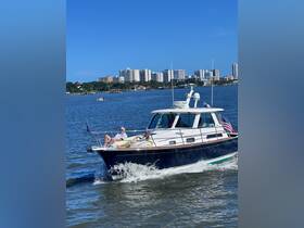 A group enjoys a leisurely day on a boat, soaking up the sun and the scenic views of the city skyline in the background — perfect for a relaxing outing on the water.
