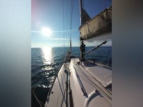 A stunning view of a sailboat gliding through calm waters under a bright sun, showcasing the beauty of sailing adventures.