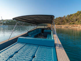 A spacious interior view of a boat featuring comfortable seating and a helm, perfect for relaxing and navigating the waters.
