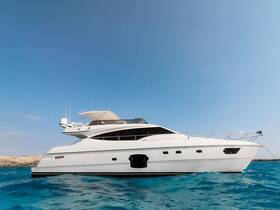 A stunning side view of a luxurious yacht cruising through clear blue waters, perfect for upscale charters and leisurely outings.