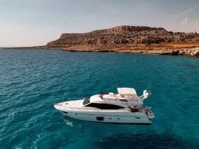 A stunning aerial view of a luxurious yacht cruising through crystal-clear turquoise waters, set against a rugged coastline — perfect for showcasing boating adventures.