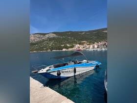 A sleek speedboat named 'AUREA' docked in a serene harbor, surrounded by picturesque hills and charming coastal buildings, perfect for a day on the water.