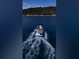 An aerial view of a boat cruising through clear waters, showcasing the serene beauty of the landscape and the joy of being on the water.