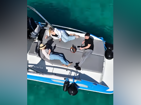 A group enjoys a relaxing day on a boat, sipping cocktails and soaking up the sun — perfect for a leisurely outing on the water.