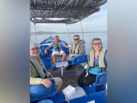 A cheerful group of friends enjoys a boat ride, showcasing camaraderie and outdoor adventure on the water.