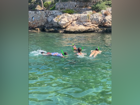 A group of snorkelers explores the clear waters, enjoying a fun day of swimming and discovering marine life. Perfect for family adventures and aquatic excursions.