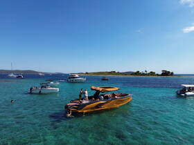 A lively scene at a sandbar with multiple boats and people enjoying the clear waters — perfect for a fun day on the water.