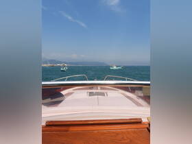 A view from the front of a boat cruising through clear waters, showcasing the vessel's sleek design against a scenic backdrop.