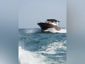 A sleek speedboat cuts through the waves, showcasing its dynamic design and performance on the water.