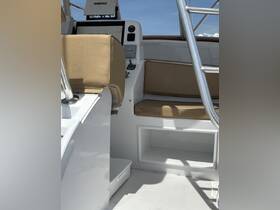 Interior view of a boat's helm and seating area, showcasing the modern console and comfortable seating, ideal for navigation and relaxation.
