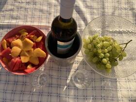 A delightful spread of fresh fruit and wine, perfect for enjoying a relaxing day on the water. Ideal for picnics or sunset cruises.