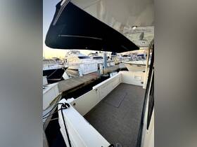 Interior view of a spacious boat cabin featuring a clean seating area, perfect for relaxing while docked at the marina.
