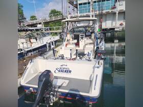 A detailed view of the 'King Stalker' sportfishing boat docked at the marina, showcasing its fishing gear and spacious design, perfect for anglers looking for a day on the water.