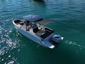 A sleek speedboat cruising through clear turquoise waters, showcasing its modern design and spacious seating — perfect for adventurous outings on the water.