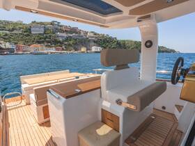 A stylish interior view of a boat's helm and seating area, showcasing modern design and comfortable amenities, perfect for a day on the water.