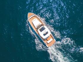A stunning aerial view of a sleek yacht cruising through deep blue waters, showcasing its elegant design and smooth movement.