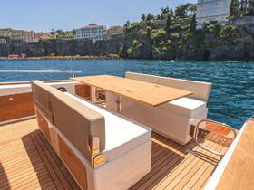 A stylish interior view of a yacht's dining area, featuring comfortable seating and a polished wooden table, perfect for enjoying meals while cruising on the water.