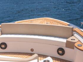 A beautifully designed seating area inside a boat, featuring elegant materials and a serene view of the water, perfect for relaxation on the water.