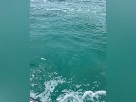 An unclear image of water with some wave activity, lacking identifiable subjects or context.