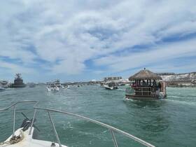 A vibrant scene of boats navigating through a scenic waterway, showcasing the lively atmosphere of island hopping adventures.