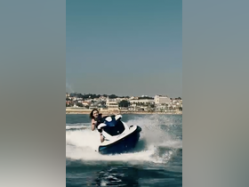 A thrilling moment captured as a rider enjoys jet skiing on clear waters, showcasing the excitement of water sports and adventure.