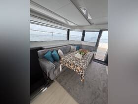 A cozy interior view of a yacht's dining area, featuring comfortable seating and a beautifully set table, perfect for enjoying meals while cruising on the water.