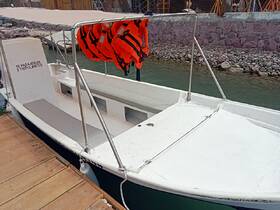 Interior view of a boat featuring seating and safety equipment, ideal for accommodating passengers on water adventures.
