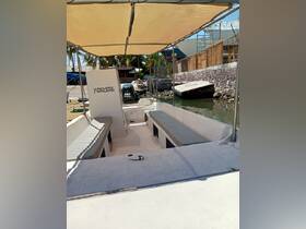 Interior view of a spacious boat cabin featuring comfortable seating, ideal for passenger comfort during excursions.