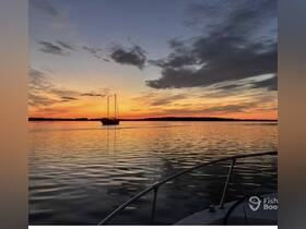 A serene sunset view featuring a sailboat silhouetted against a vibrant sky, perfect for capturing the tranquility of evening on the water.