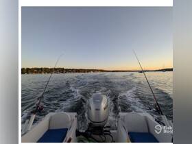 A scenic view from a fishing boat as it cruises through calm waters at sunset, showcasing the perfect setting for a relaxing fishing trip.