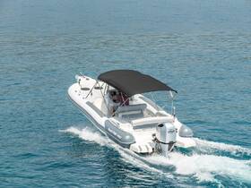 A sleek speedboat glides through clear waters, showcasing its design and performance on the open sea.