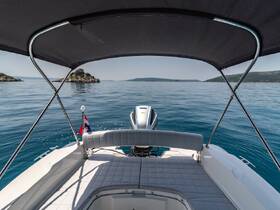 A serene view from the back of a boat, showcasing the calm waters and distant islands — perfect for a relaxing day on the water.