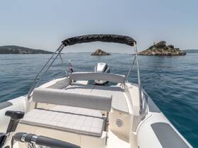 A clean and spacious interior view of a boat's helm and seating area, perfect for enjoying a day on the water while exploring beautiful coastal destinations.