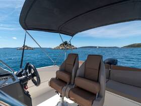 A well-appointed helm area featuring comfortable seating and a clear view of the serene waters, perfect for navigating scenic routes.