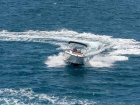 A speedboat glides through the vibrant blue waters, showcasing an exhilarating day on the sea.