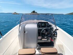 A well-equipped helm area of a boat featuring a modern console and comfortable seating, perfect for navigating the open waters.