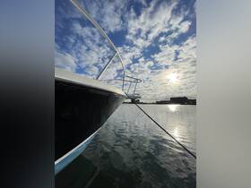 A striking view of a boat's bow against a backdrop of dramatic clouds and shimmering water, perfect for showcasing the beauty of boating.