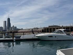 A sleek yacht docked at a marina with a stunning city skyline in the background, showcasing the perfect blend of urban and nautical scenery.