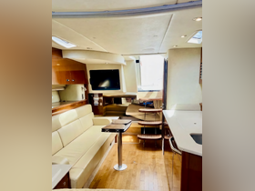 A spacious and elegantly designed interior of a boat featuring comfortable seating and modern amenities, perfect for relaxing during a day on the water.