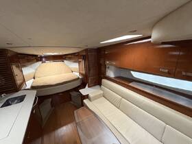 Interior view of a cozy boat cabin featuring a comfortable seating area and a spacious bed, perfect for relaxation during your nautical adventures.