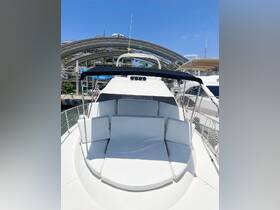 A spacious lounge area on a yacht, featuring comfortable white seating perfect for relaxation while enjoying the views on the water.