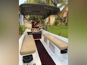 Interior view of a boat showcasing comfortable seating and a stylish design, perfect for relaxing on the water.