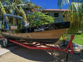 A sleek boat named 'Rita Berry' is showcased on a trailer, surrounded by lush greenery, perfect for a day out on the water.