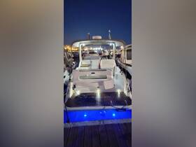 A well-lit interior view of a boat's helm and seating area, showcasing the cozy cabin design perfect for evening outings.