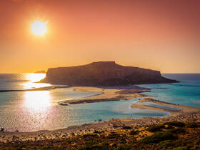 A breathtaking sunset view over a serene coastline, showcasing the natural beauty of the island and its tranquil waters — perfect for nature lovers and photographers.