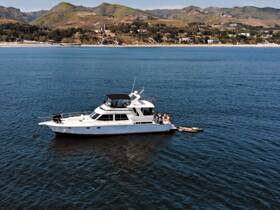 A group enjoys a sunny day on a yacht, showcasing the perfect setting for water activities and relaxation.