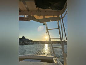 A serene view from inside a boat's helm, capturing the sunset over the marina — perfect for those seeking a peaceful evening on the water.