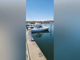 A sleek speedboat docked at the marina, showcasing its design against a clear blue sky — perfect for fishing or leisure outings.