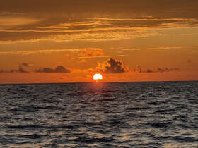 A stunning sunset over the ocean, casting vibrant colors across the sky — a perfect backdrop for romantic evenings or serene boat trips.