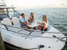 A group of friends enjoys cocktails on the deck of a boat, creating the perfect atmosphere for a fun-filled day on the water.
